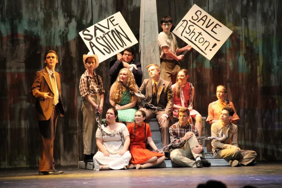 Junior Ty Dalrymple and the ensemble sings onstage in the musical “Big Fish” on Oct. 30 at Coppell High School. “Big Fish” is Dalrymples eighth show at CHS. His character, Edward Bloom is suggesting an idea to save his hometown Ashton in the song “Start Over”. Photo by Maggie Theel.