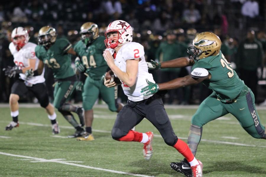 Coppell High School sophomore and quarterback Brady McBride runs the ball towards the end zone during the end of the first quarter on Friday night’s game at Eagle Stadium. The DeSoto Eagles defeated Coppell with a final score of 35-31, knocking Coppell out of the playoffs. Photo by Amanda Hair.