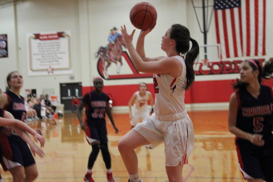During+the+beginning+of+the+third+quarter+of+Friday+night%E2%80%99s+game%2C+Coppell+High+School+senior+Kaylie+Stayer+goes+in+for+a+layup+to+bring+the+score+to+32-20.+Coppell+kept+the+lead+over+John+Paul+II+for+the+entire+game%2C+ending+with+a+final+score+of+51-28.+Photo+by+Amanda+Hair.