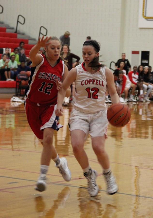 Coppell High School senior shooting guard Kaeli Stayer dribbles across the court in the Cowgirls 33-32 victory over Grapevine Tuesday night at Coppell High School. 
