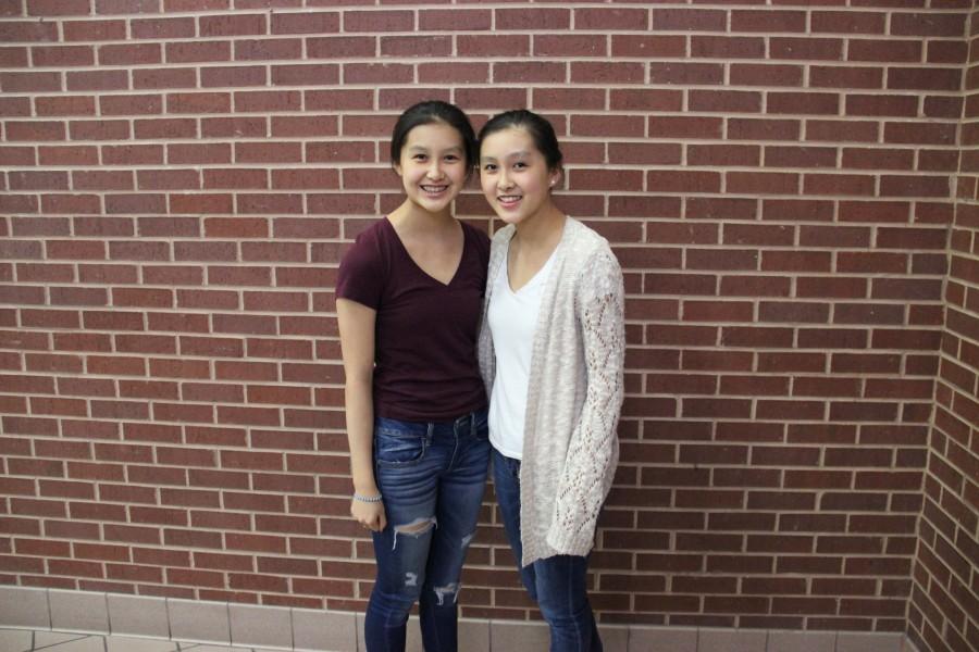 “Coppell High School sophomores Robin Li and Megan Li are identical twins. The girls personalities are both very different. Megan is more talkative and girly while Robin is more reserved and direct. A physical distinguishing feature between them is that Megan has a mole on the top of her head while Robin does not.
