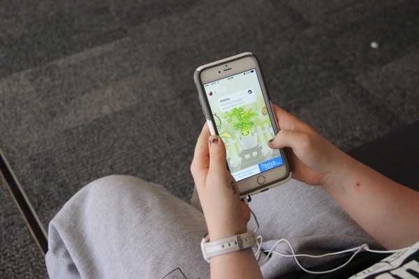 Coppell High School junior Lauren Harris collects seeds from Gatsby the Devil’s Ivy in her virtual garden on the app Plant Nanny. Harris uses Plant Nanny on a daily basis to track the amount of water she drinks.