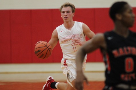  During the second quarter of Friday night’s game, Coppell High School senior and point guard Josh Fink looks to pass the ball in the CHS large gym. After a close game, the Coppell Cowboys claimed a victory over the Haltom Buffalos with a final score of 50-45. 