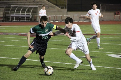 Coppell High School senior and fullback Brandon Bohn attempts to steal the ball from a Carroll High School forward during the first half of Friday night’s game at Buddy Echols Field. The Coppell Cowboys claimed a victory over the Southlake Carroll Dragons with a final score of 6­-0. 