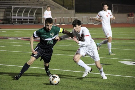 Coppell High School senior and fullback Brandon Bohn attempts to steal the ball from a Carroll High School forward during the first half of Friday night’s game at Buddy Echols Field. The Coppell Cowboys claimed a victory over the Southlake Carroll Dragons with a final score of 6-0. Photo by Amanda Hair.