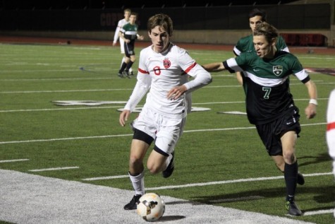 Within the final minutes of Friday night’s game, Coppell High School senior and midfielder Scott Simigian dodges oncoming Southlake Carroll defenders at Buddy Echols field. After keeping the lead over Southlake Carroll for the entirety of the game, the Cowboys defeated the Dragons with a score of 6-0. Photo by Amanda Hair.