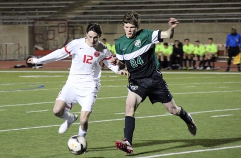 Coppell High School senior and fullback Brandon Bohn dribbles the ball past oncoming Southlake Carroll defenders at Friday night’s game at Buddy Echols Field. With a constant lead over the Dragons, Coppell claimed a 6-0 victory over Southlake Carroll. Photo by Amanda Hair.