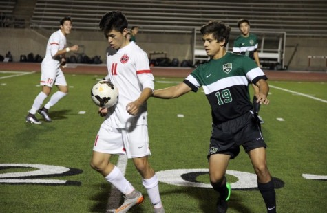 As Friday night’s game at Buddy Echols Field comes to a close, Coppell High School junior and forward Nick Taylor chests the ball as an opposing Southlake Carroll player attempts to steal the ball. After keeping the lead over Southlake Carroll for the entirety of the game, the Cowboys defeated the Dragons with a score of 6-0. Photo by Amanda Hair.