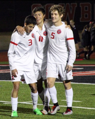 Coppell High School forwards Rodrigo Zuniga (left), Nick Taylor (middle), and Tanner Traw (right) all share a hug after Taylor scored the sixth and final goal of Friday night’s game against Southlake Carroll. After keeping the lead over Southlake Carroll for the entirety of the game, the Cowboys defeated the Dragons with a score of 6­0 at Buddy Echols Field.