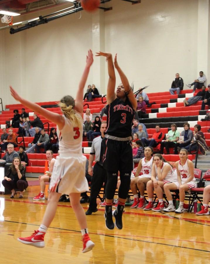 Trinity High School  junior shooting guard Trinity Oliver shoots and scores as she is being guarded. Trinity High School defeated Coppell with a score of 60-35 in the CHS large gym. Photo by Ale Ceniceros. 