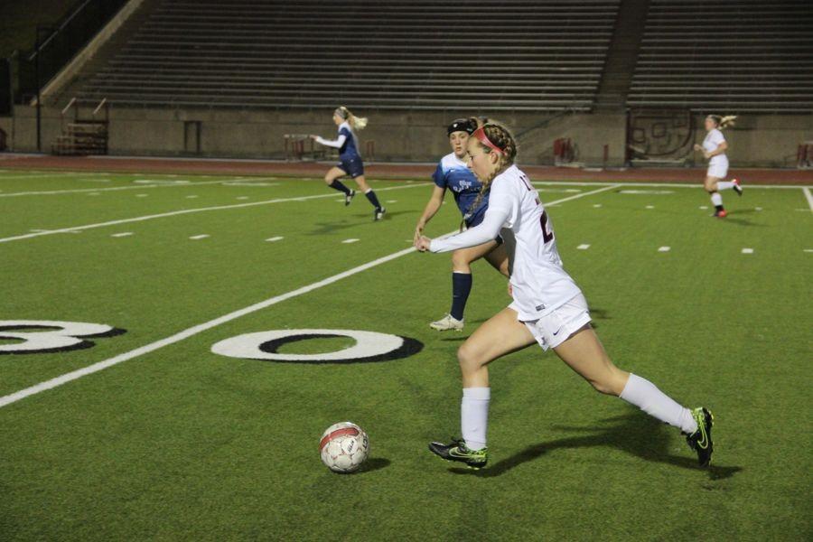 Coppell High School junior Erian Brown dribbles the ball down the field right before scoring the first goal of the game on Jan. 26. The Coppell Cowgirls defeated L.D. at Bell 4-0 at Buddy Echols Field.