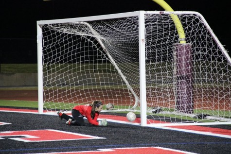 Coppell High School junior Sarah Houchin scores a goal against the L.D. Bell goalie on a penalty kick, making the score 2-0 on Jan. 26. The Coppell Cowgirls defeated L.D. at Bell 4-0 Buddy Echols Field.