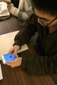 Coppell High School senior Alan Wang pulls up the Everest App on his phone in class. Wang uses Everest to organize his life and to help him keep track of his goals.