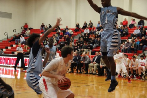 Coppell High School senior forward Drew Smith gets a Bell defender in the air with a pump fake during Coppell’s 35-34 loss to the Blue Raiders. In the final seconds, Smith put up a good shot, but it did not fall, giving the Cowboys their first district loss.