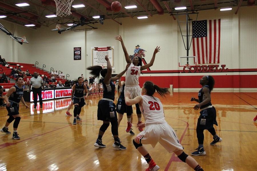 Coppell High School junior center Chidera Nwaiwu shoots the ball as a player from L. D. Bell attempts to defend the basket. The Cowgirls lost to the Lady Raiders 39-26.

