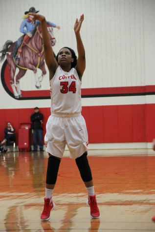 Coppell High School junior Chidera Nwaiwu throws a free throw during the first quarter scoring a point for the Cowgirls. Coppell was defeated by Haltom with a final score of 43-35 on Friday night’s game in the CHS large gym. 