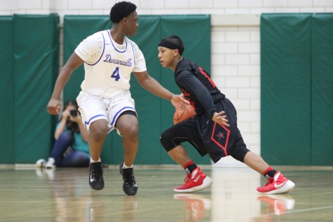 Freshman guard Tariq Aman looks for an open lane in the Duncanville defense during Coppell's 72-61 overtime loss to the Panthers. Throughout the season, Aman was one of the biggest contributors from underclassman and will be looked upon next year as a key piece of the program.