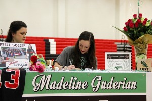 Coppell High School senior Madeline Guderian signs with University of North Texas on National Signing Day in the main gym on Wednesday. Guderian will play soccer with the university in the fall. Photo by Mallorie Munoz.