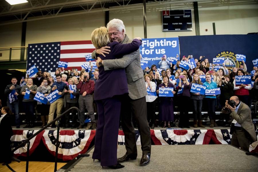 Presidential candidate Hillary Clinton and her husband and former President Bill Clinton hug as they join supporters at Nashua Community College in Nashua, N.H., on Tuesday, Feb. 2, 2016, after she was officially declared the winner of the Iowa caucus. (Ryan Mcbride/Zuma Press/TNS)
