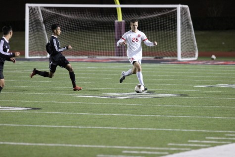 Coppell High School junior defensive player Laurence Fairchild steals the ball from Haltom player Tuesday night at Buddy Echols Field. The Coppell Cowboys defeated the Haltom Buffalos, 11-3. Photo by Aubrie Sisk. 
