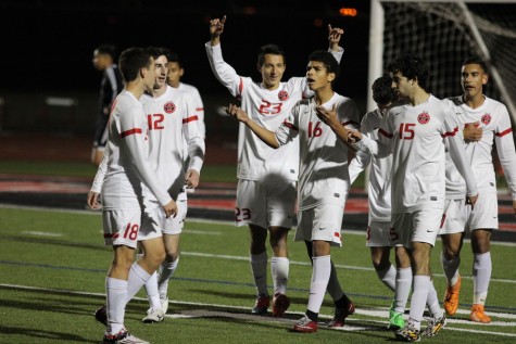 The Coppell High School Cowboys celebrate their 11-3 victory over the Haltom Buffalos on Tuesday night at Buddy Echols Field. The victory improves the Cowboys to 11-0-2 in District 7-6A. Photo by Aubrie Sisk. 