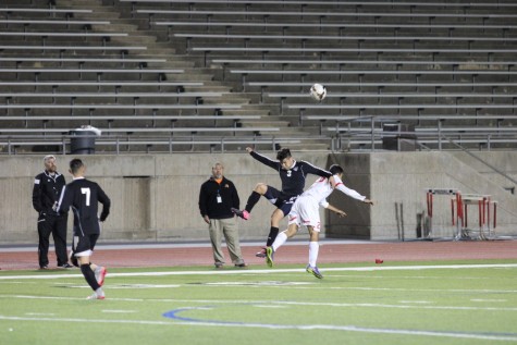 Coppell High School senior defensive player Manuel Martinez collides with a Haltom player while attempting a header on Tuesday night at Buddy Echols Field. Coppell defeated Haltom, 11-3. Photo by Aubrie Sisk. 
