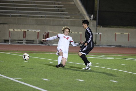 Coppell High School junior midfielder Parker McClure maneuvers the ball away from the opposing Haltom player on Tuesday night at Buddy Echols Field. Coppell defeated Haltom, 11-3. Photo by Aubrie Sisk. 