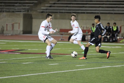 Coppell High School junior defender Laurence Fairchild guards the opposing Haltom player while junior defender Jordan Pemberton watches to see if extra help is needed on Tuesday night at Buddy Echols Field. The Coppell Cowboys defeated Haltom Buffalos, 11-3. Photo by Aubrie Sisk. 
