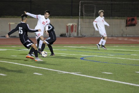 Coppell High School senior forward Marcelo Gaitan steals the ball away from the opposing Haltom players at Buddy Echols Field on Tuesday night. Coppell defeated Haltom, 11-3. Photo by Aubrie Sisk. 