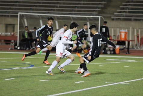 Coppell High School senior midfielder Waleed Cherif guards an opposing Haltom player at Buddy Echols Field on Tuesday night. Coppell defeated Haltom, 11-3. Photo by Aubrie Sisk. 