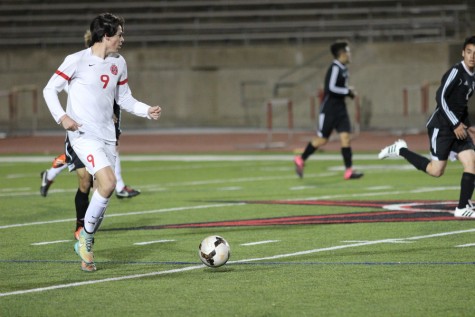 Coppell High School junior midfielder Alex Haas looks for an open teammate while heading to the goal during the game against Haltom on Tuesday night at Buddy Echols Field. The Coppell Cowboys beat the Haltom Buffalos, 11-3. Photo by Aubrie Sisk. 