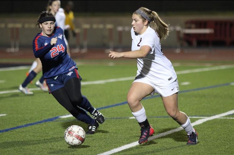  During the first half of Friday night’s game against Richland, Coppell High School senior Ashleigh Little dribbles the ball down the field as she looks to pass the ball to CHS junior Tori Teffeteller. After keeping the lead the entire game, Coppell ended the night with an 8-0 victory over Richland.