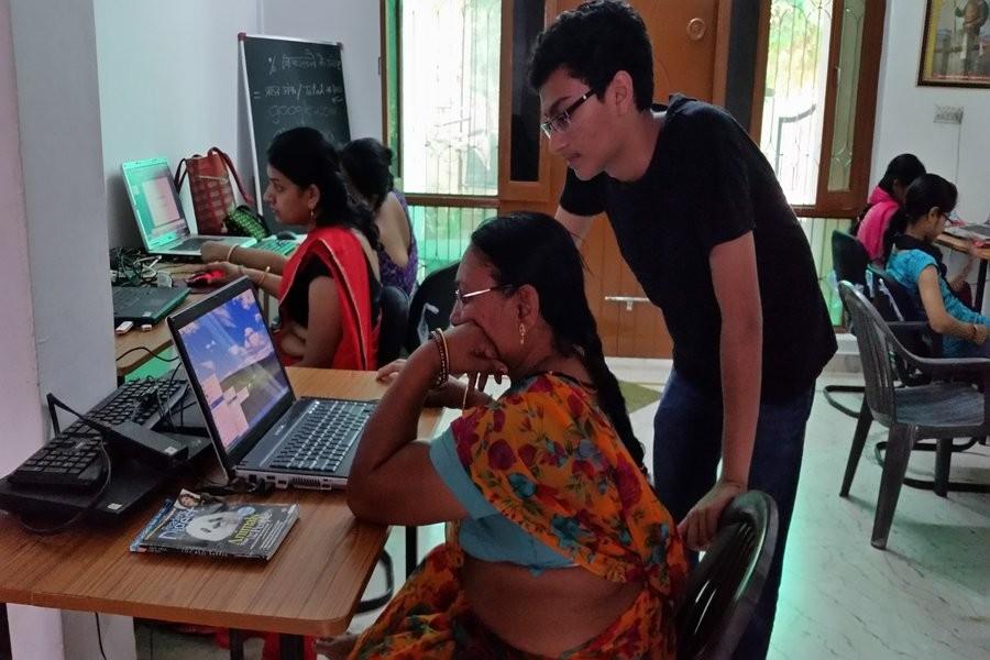 Sophomore Pranjal Jain helps teach the basics of a computer to people who come to the computer lab. Photo courtesy Pranjal Jain.