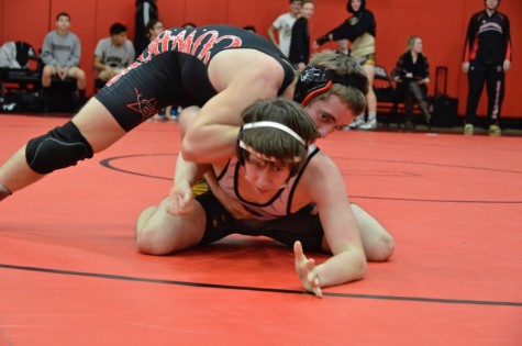 Coppell High School senior Austin Hanson pins his Panthers opponent down on Thursday at the Coppell High School small gym. The JV wrestling team prepares to go against Flower Mound in the District 6 JV Championships this Wednesday.