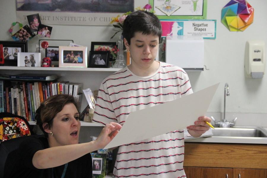 Coppell High School art teacher Elsa Reynolds instructs sophomore Jacob Cacheria on ways he can improve his drawing during 5th period on Tuesday in room E102. Students in Reynolds’ Art I class is learning to draw an interior of a room from a specific perspective.