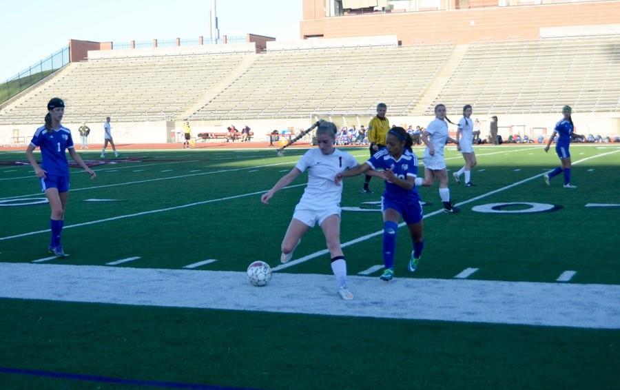 Coppell High School senior Shay Johnson fights against Duncanville for the soccer ball on March 24 at Buddy Echols field. Coppell Cowgirls defeated Duncanville 1-0 in the first round of playoffs.