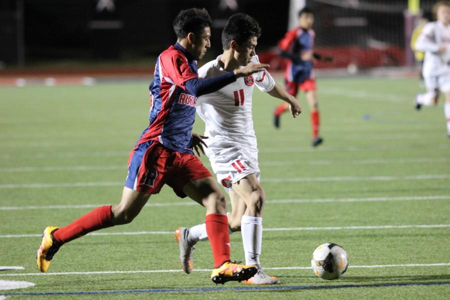 Junior forward Nick Taylor attempts to dribble past the Richland defense in the Cowboys 9-0 victory at Buddy Echols field. Taylor had three goals in the first 18 minutes to lead the Cowboys to a win.