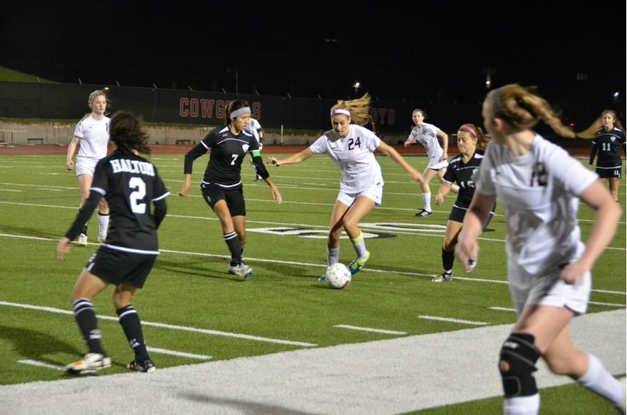 Coppell High School senior Emma Jett evaluates where to kick the soccer ball next last Friday at Buddy Echols Field. The Varsity Coppell Cowgirls won 4-1 against Haltom.
