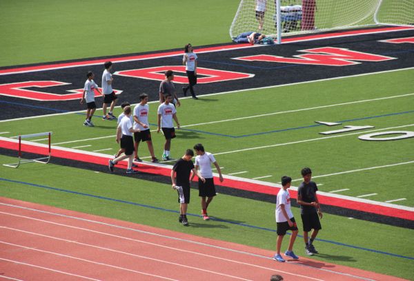 Coppell High School’s team sports class walks the track on Wednesday during fifth period on Buddy Echols Field. There is a variety of physical education classes you can take like outdoor adventures, individual sports, personal fitness and aerobics. A year of physical education is required to grade. 