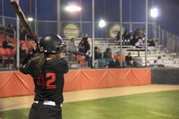 Coppell High School senior Julia Sircar  warms up before the fifth inning. The Cowgirls played Haltom High School at the Coppell ISD Baseball/Softball Complex at Coppell Middle School West and won the game 10-0. 
