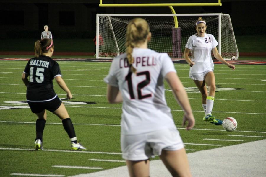 Coppell senior Emma Jett passes to senior Caitlyn Hiller during the first half of Fridays game against Haltom. Jett scored two goals as the Cowgirls cruised to  a 12-0 win. Photo by Ayoung Jo.
