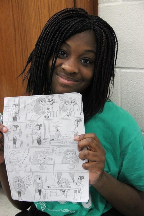Coppell High School sophomore Monique Ikhile proudly shows her cartoon in room F107 during fifth period on Wednesday. Ikhile likes drawing cartoon characters as a hobby and may venture into the art field in the future.