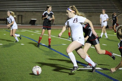 Junior defender Sarah Houchin dribbles past a Trinity defender in pursuit of a goal. Houchin scored one goal in a 7-0 win for the Cowgirls. Photo by Kelly Monaghan.