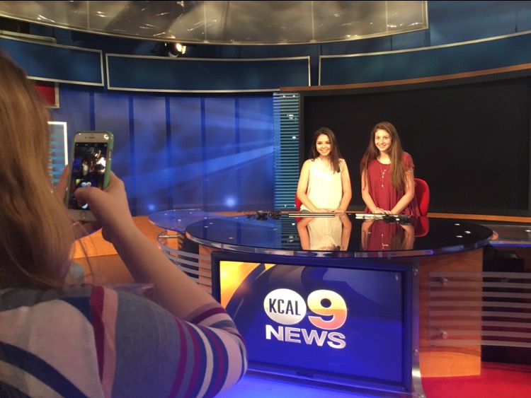 Coppell High School junior members of The Sidekick Kelly Monaghan (left) and Aubrie Sisk (right) pose in the CBS Studio Center in Los Angeles for during a tour on Thursday afternoon. All students were able to watch a live broadcast of the CBS Los Angeles news after receiving a full tour of the building.