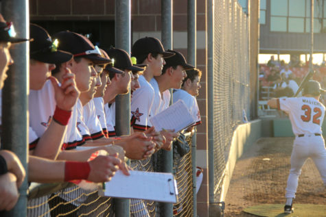 The Cowboys watch the field as Cole Solomon is at bat. The Cowboys won their district game 2-0 against Colleyville Heritage. Photo by Ayoung Jo.