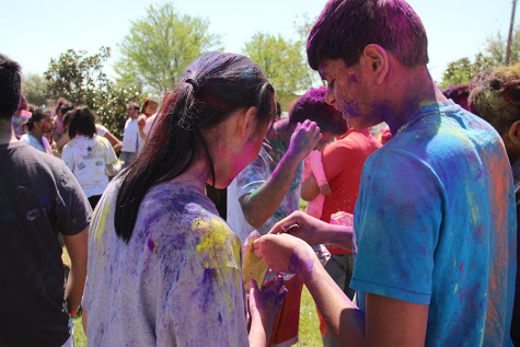 Coppell High School seniors Sriram Palepu and Grace Lu trade Holi powders on Sunday at the at the DFW Hindu Temple. According to ReligionFacts, “In Hinduism, Holi (also called Holaka or Phagwa) is an annual festival celebrated on the day after the full moon in the Hindu month of Phalguna (early March). It celebrates spring, commemorates various events in Hindu mythology and is time of disregarding social norms and indulging in general merrymaking.”