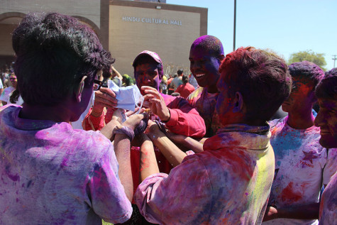 Coppell High School senior Vinayak Sahal shares his Holi powders with other CHS students in attendance of the festival at the DFW Hindu Temple on Sunday. According to ReligionFacts, “The central ritual of Holi is the throwing and applying of colored water and powders on friends and family, which gives the holiday its common name ‘Festival of Colors’. This ritual is said to be based on the above story of Krishna and Radha as well as on Krishna's playful splashing of the maids with water, but most of all it celebrates the coming of spring with all its beautiful colors and vibrant life.” 