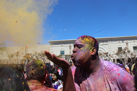 Coppell High School senior Chisom Ukoha blows the Holi powder over a crowd at the DFW Hindu Temple on Sunday. According to The Society for the Confluence of Festivals in India, “Holi is also called the Spring Festival - as it marks the arrival of spring the season of hope and joy. The gloom of the winter goes as Holi promises of bright summer days.”