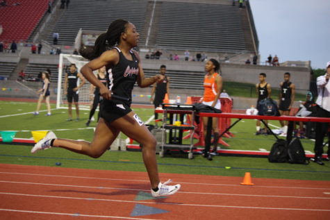 Coppell High School junior Lauren Cunningham sprints to the finish line at the end of the women’s 4x200 relay. The District 7-6A Track & Field Meet was held at Buddy Echols Field and athletes from all over the district participated in events on Monday and Tuesday. Photo by Kelly Monaghan. 