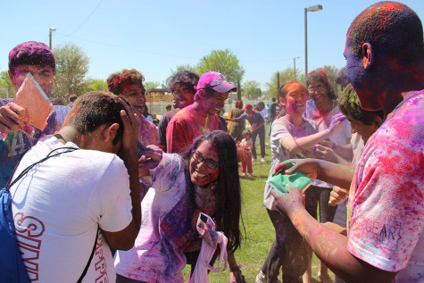 Coppell High School senior Vinay Kalvacherla shields himself from Holi powder by senior Aditi Mukund during Holi at the DFW Hindu Temple on Sunday. “It’s an awesome festival that can give me a chance to express myself and my heritage and feel connected to other people in my community and religious community,” Mukund said. “It’s a really fun day filled with colors and the beginning of spring.”